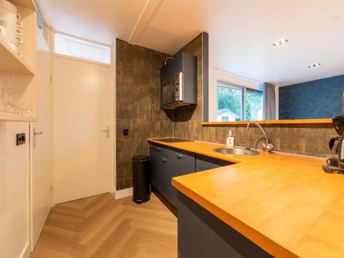 a kitchen with a sink and a counter top at Cozy holiday home in South Holland in a wonderful environment in Zevenhuizen