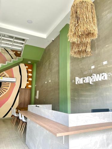 a lobby of aarmaarmaarmaarma restaurant with a sign on the wall at Hotel Paranawa in Baranoa