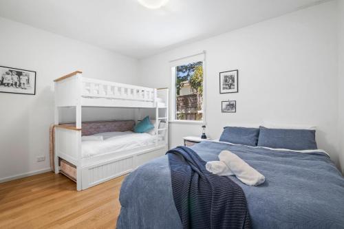 a bedroom with a bed and a bunk bed at Sea Corner in Anglesea