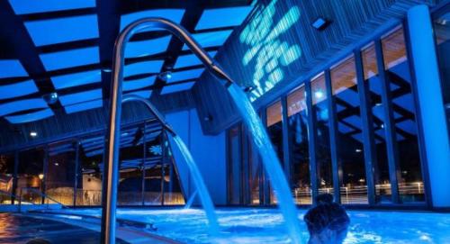 a person in a swimming pool at night at Residence bois d'aurouze pied des pistes in Le Dévoluy