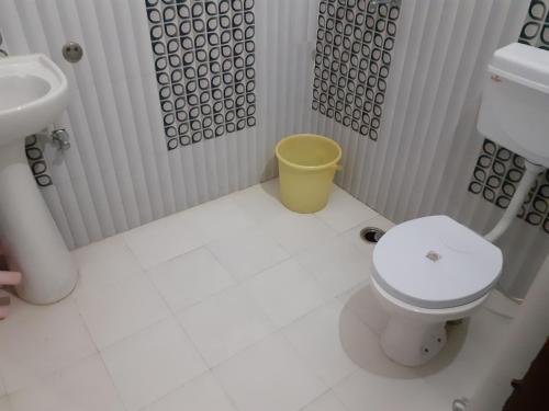 a bathroom with a toilet and a sink at Hotel aasra guest house in Bharwain