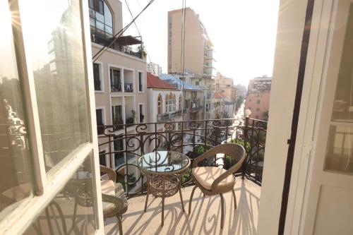 a balcony with chairs and a table on a balcony at THE GEM BOUTIQUE HOTEL in Beirut