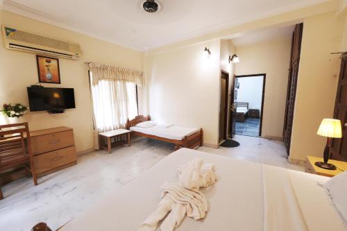 a bedroom with a bed with a towel on it at Metropolitan Serviced Villa in Cochin