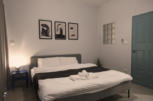 a bedroom with a bed with a stuffed animal on it at 4 bedrooms, Private & Cozy house @ Walking Street in Chiang Rai