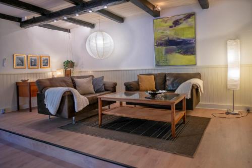 a living room with a couch and a table at Cosy One Villa in Struer