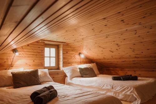 a room with two beds in a wooden cabin at Tranquility with Luxury in Maardu