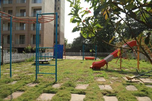 a playground with a slide in a park at The Retreat by City Homes Aashiyaanaa in Jambhulpāda