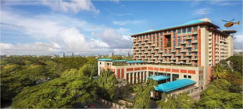 an aerial view of a hotel building with trees at ITC Gardenia, a Luxury Collection Hotel, Bengaluru in Bengaluru