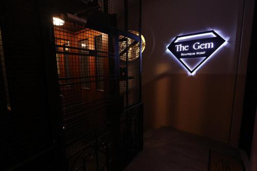 a sign that reads the scam in a dark room at THE GEM BOUTIQUE HOTEL in Beirut