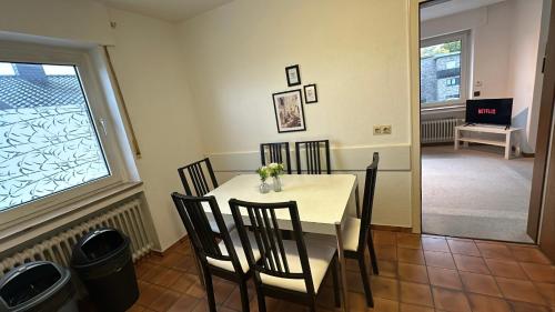 a dining room with a table and chairs and a window at Beautiful Apartment in Ibbenbüren in Ibbenbüren