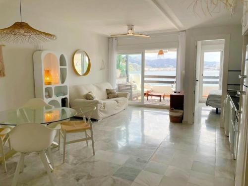 a living room with a couch and a glass table at Marina Sunrise in La Herradura