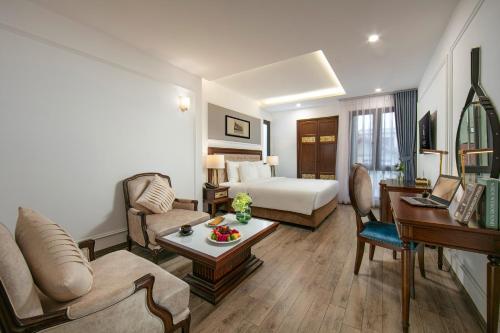a hotel room with a bed and a living room at Gloud Hotel in Hanoi