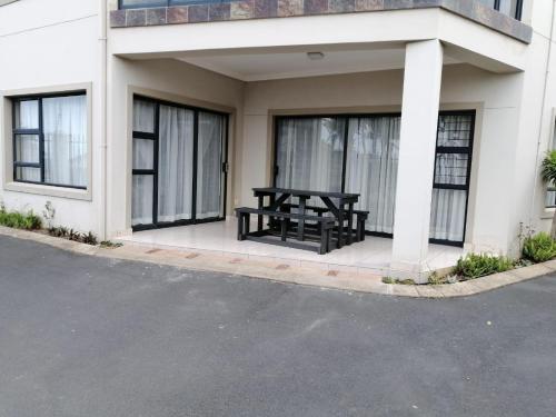 a black picnic table on the side of a building at 24 Topanga in Uvongo Beach