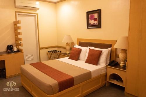 Habitación de hotel con 1 cama y 2 lámparas en PHELA GRANDE HOTEL en General Santos