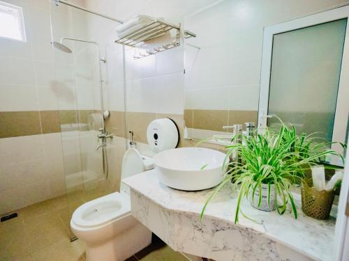 a bathroom with a sink and a toilet at Thang Loi BTX Hotel in Da Lat