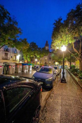 a group of cars parked on a city street at night at dúplex st Pere OnyarapartamentsCom in Girona