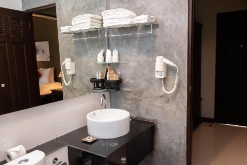 a bathroom with a sink and a mirror at Victoria Cliff Hotel & Resort, Kawthaung in Kawthaung