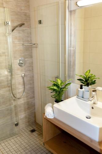 a bathroom with a sink and a shower at Erlenhof in Maria Alm am Steinernen Meer