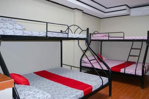 a room with two bunk beds in a room at Mommy Linda Beach Resort in Cabangan