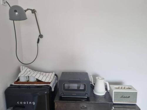 a desk with a printer and a lamp on it at B&G House in Gyeongju