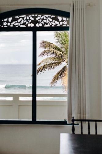 a window with a view of the ocean at Lighthouse Ahangama in Ahangama