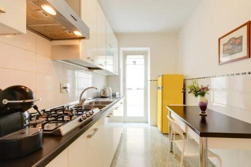 a kitchen with a stove and a yellow refrigerator at Locazione turistica Roman style near San Pietro in Rome