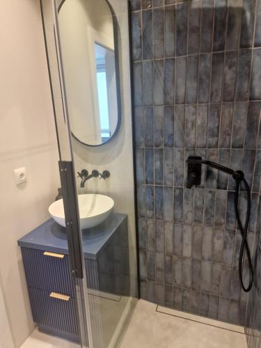 a bathroom with a sink and a mirror at mieszkanie w centrum in Konin