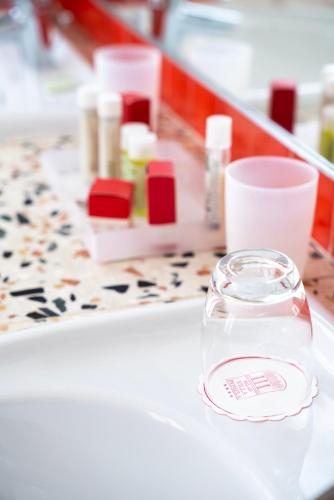 a table with a glass jar of cosmetics on it at Relais Villa Pomela in Novi Ligure