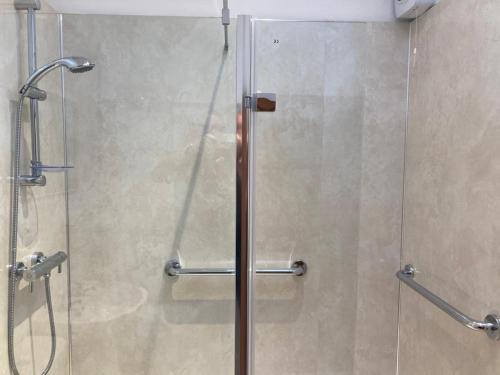 um chuveiro com uma porta de vidro na casa de banho em The Stables em Metheringham