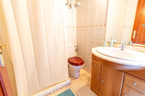 a bathroom with a toilet and a sink and a shower at RentitSpain Casa Abanico a pasos de Castillo de Salobreña in Salobreña