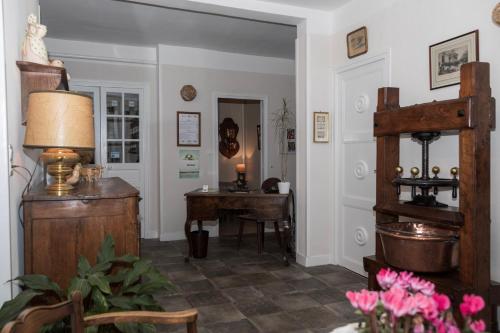 a living room with a desk and a table at Cit'Hotel Aéro-Hotel in Le Blanc-Mesnil