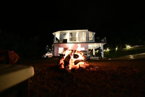 a fire in front of a house at night at RK MOUNT ORCHID coorg in Madikeri