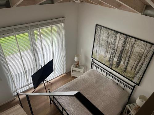 a bedroom with a bed and a large window at Löftchen in Roetgen