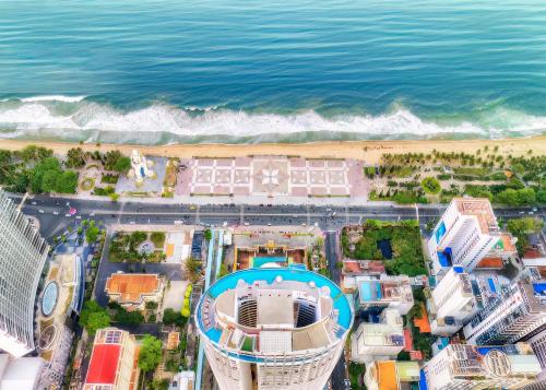 an aerial view of a beach with buildings and the ocean at OceanDream Panorama Luxury Suites in Nha Trang