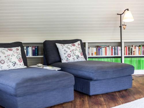 a living room with a couch and a ottoman at Ferienhaus REETselig mit Pool Sauna in Klein Barkau