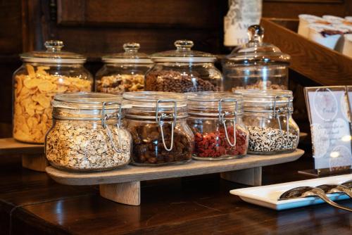 a group of jars of seeds and nuts on a table at Relais Villa Pomela in Novi Ligure