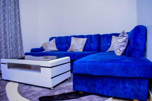 a blue couch and a chair in a living room at ROYALSTAYCATION in Ruiru