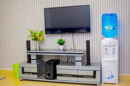 a entertainment center with a tv on a wall at ROYALSTAYCATION in Ruiru