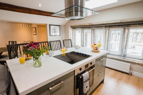 a kitchen with a sink and a counter top at Swan House in Huddersfield
