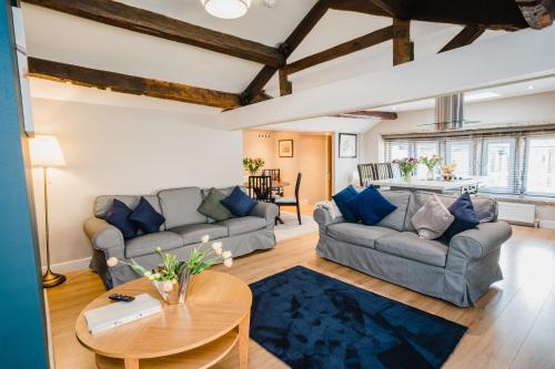 a living room with two couches and a table at Swan House in Huddersfield