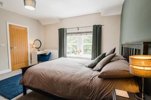 a bedroom with a large bed and a window at Swan House in Huddersfield