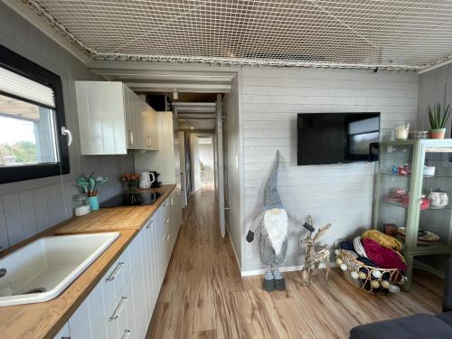 une cuisine avec des placards blancs et un comptoir dans l'établissement Domek Veli Stawinoga, à Stawinoga
