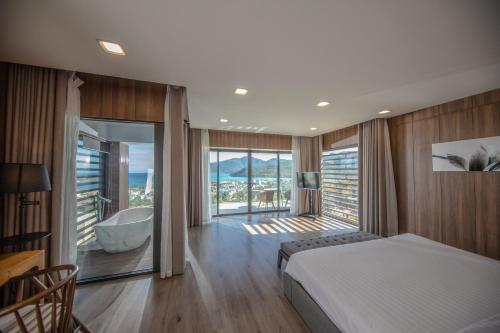 a bedroom with a bed and a tub in a room at Promotion Early Booker Corner Villa 5 Bedrooms infinity Pool & BBQ Outdooor in Nha Trang