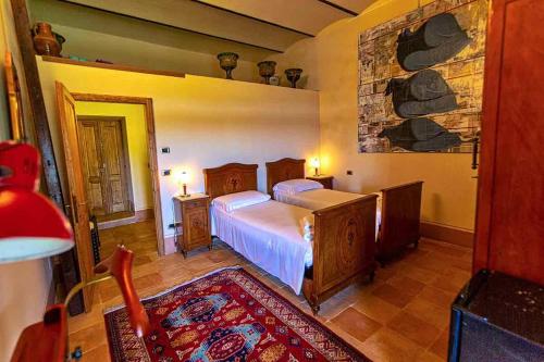 a bedroom with a bed and a stone wall at Podere Calvaiola in Montecatini Val di Cecina