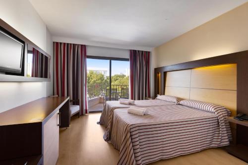 ein Hotelzimmer mit einem Bett und einem Balkon in der Unterkunft Hotel Pabisa Chico in Playa de Palma