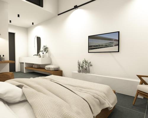 Habitación blanca con cama y lavabo en Hotel Angels en Mythimna