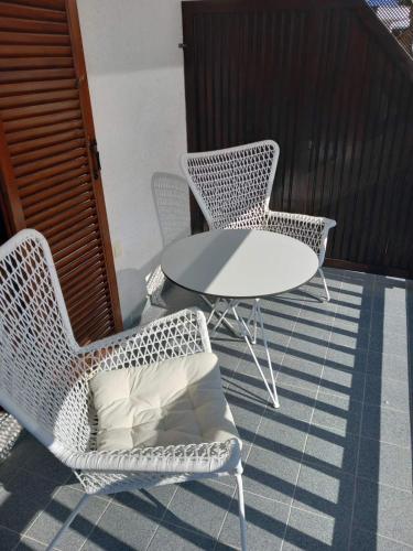 a table and two chairs and a table with a pillow at Amaryllis Luxury Rooms in Platamonas