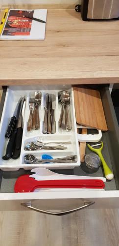 a drawer filled with utensils on top of a table at Harmonie 
