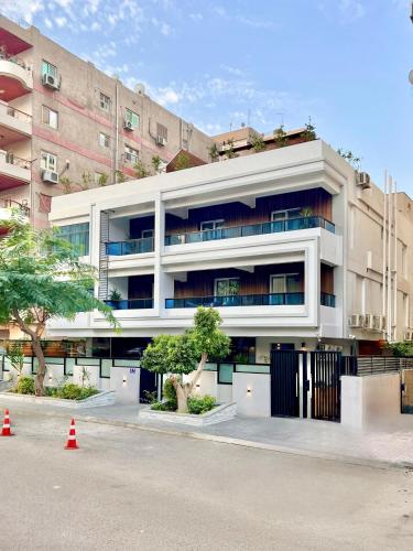 a large white building with trees in front of it at مخصص للعوائل فقط Four Elements in Cairo
