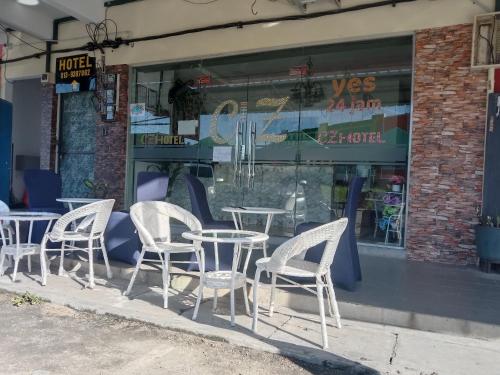 a group of tables and chairs in front of a store at CZ CLASSIC in Pasir Puteh